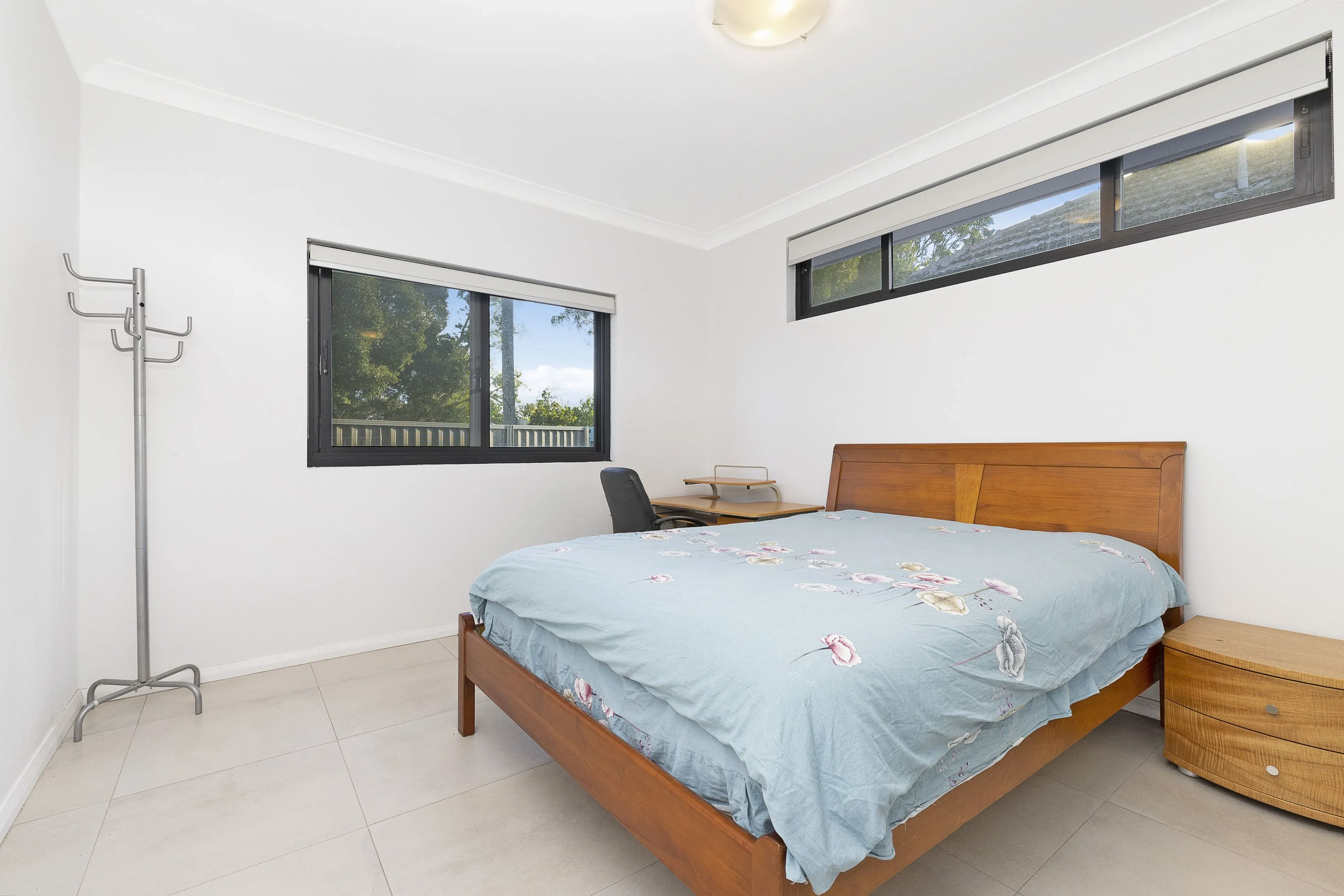 A calm bedroom with a queen bed and garden views.