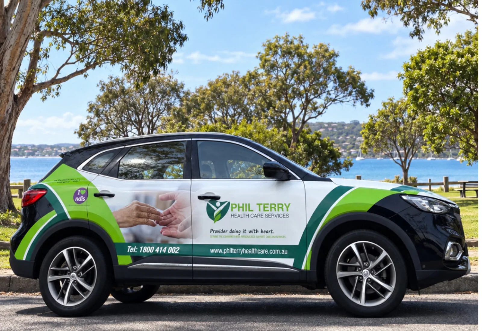 A Phil Terry Health Care branded car parked by the water.