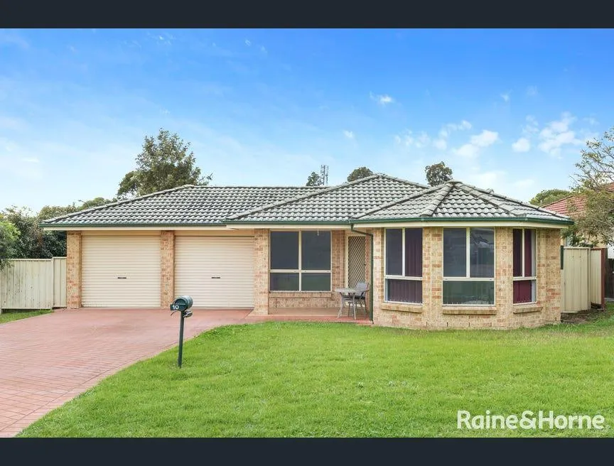 A brick family home in Mascot with a double garage, bay windows and a generous front lawn.