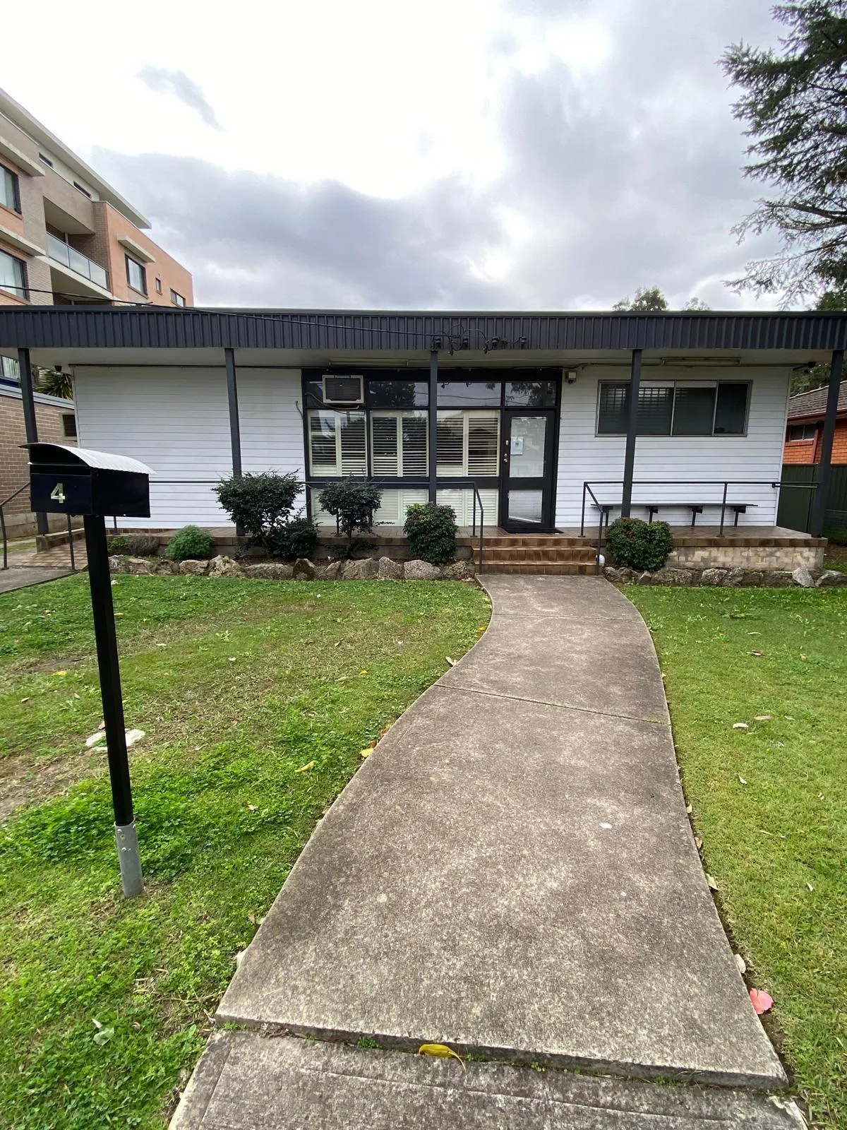 A single-level white home in Mt Druitt with a wide covered veranda and level path to the front door.